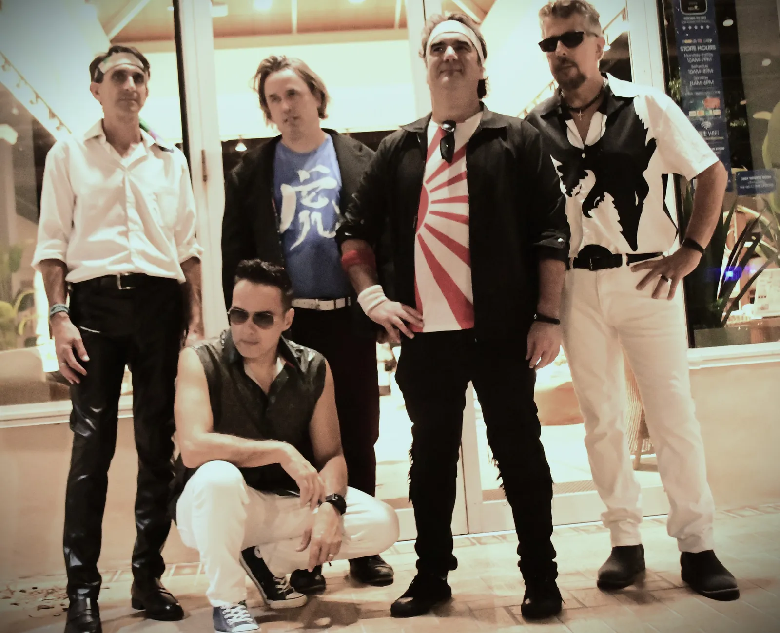 The five members of Notorious posed together in 80s style